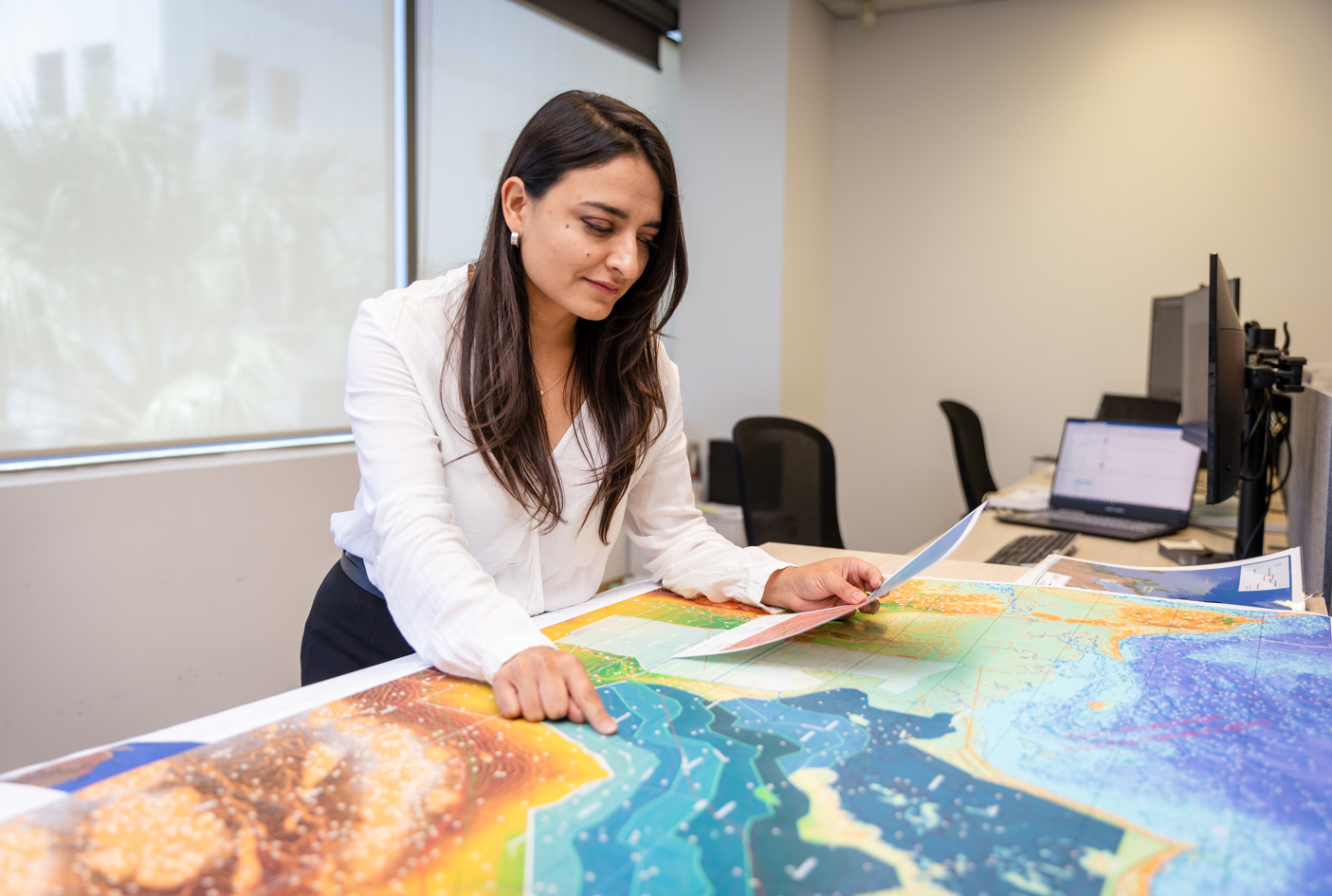 Leic team in office with map